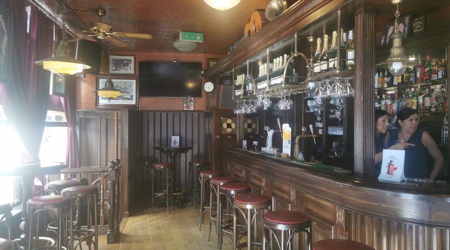 A classic bar with a semicircular counter, high chairs.