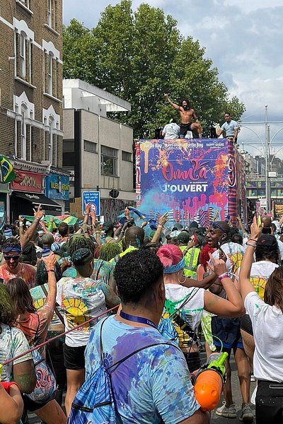 런던의 노팅힐 카니발에서 뮤직 트럭을 따라가며 파티를 즐기는 사람들