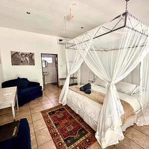 Deluxe Double Room - with an ensuite bathroom, kettle, a/c, security safe, mosquito net and includes a free basic breakfast.  Garden View.