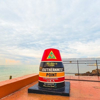 A large red, orange, and black marker that marks the Southernmost Point of the USA