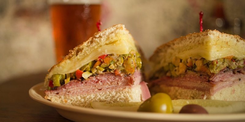 Two quarters of a muffuletta sandwich