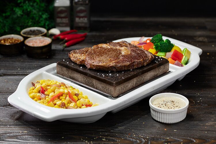 BLACK ROCK TOP RIB-EYE STEAK 280g, Served with any two sides and your choice of Mushroom Sauce, Pepper Sauce, Chimichurri Sauce or Entrecôte Sauce on the side.
