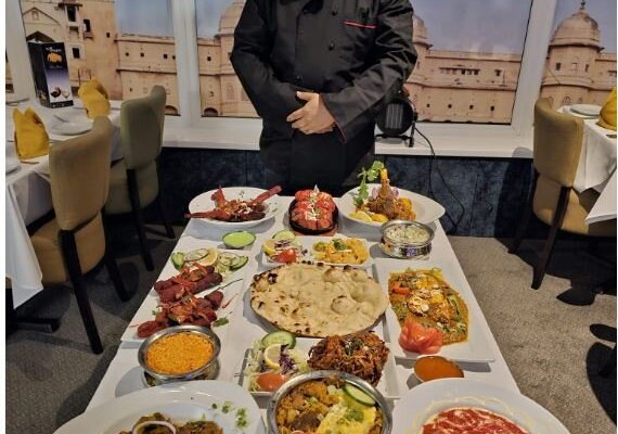 Our Chef with a range of different dishes we serve at The Three Mughals 