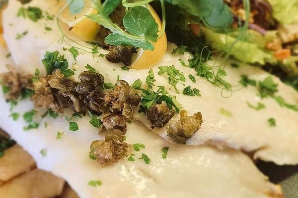 Baked fish with crispy capers and cream herb parmesan sauce