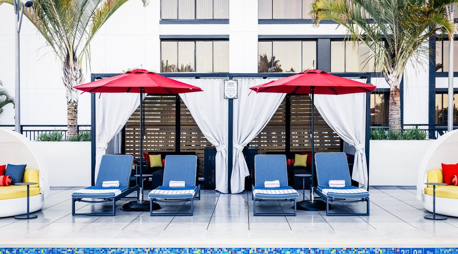 Pixar Place Hotel at Disneyland Resort Pixel pool cabana with lounge chairs and umbrellas
