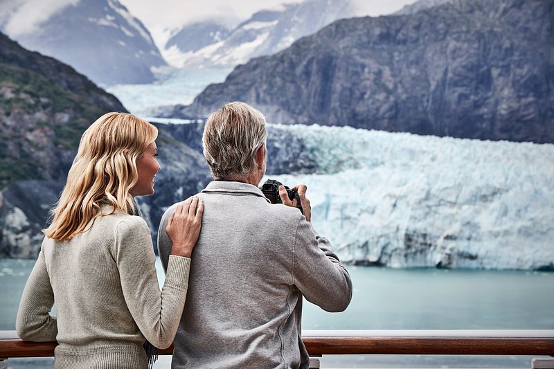 Couple looking our at the glaciers in Alaska from a cruise ship