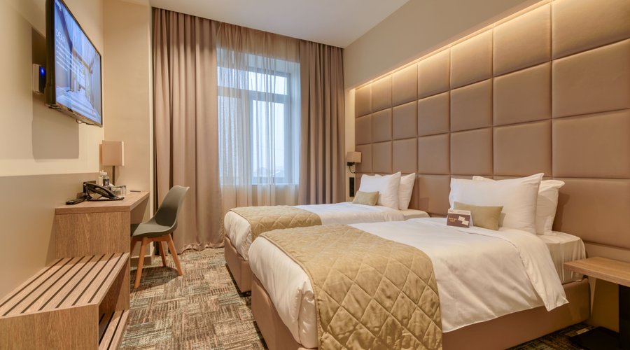 Standard Room/King/Twin The comfortable standard rooms have everything guests need: a comfortable bathroom, modern decor, cozy beds with high-quality mattress, WIFI, 43 inch Smart and interactive TV. Amenities and Facilities Complimentary teapot, tea, coffee and water, notepads, bathroom amenities, an iron and ironing board, Interactive TV, in room laptop size safe, hangers, a mini-bar (at an additional price), hygienic shower in all rooms. Interconnected room available Mansard rooms available 