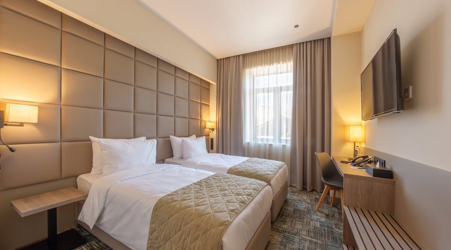 Standard Room/King/Twin The comfortable standard rooms have everything guests need: a comfortable bathroom, modern decor, cozy beds with high-quality mattress, WIFI, 43 inch Smart and interactive TV. Amenities and Facilities Complimentary teapot, tea, coffee and water, notepads, bathroom amenities, an iron and ironing board, Interactive TV, in room laptop size safe, hangers, a mini-bar (at an additional price), hygienic shower in all rooms. Interconnected room available Mansard rooms available