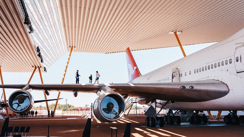 Tourists viewing airplane at the Qantas Founders Museum, in Queensland