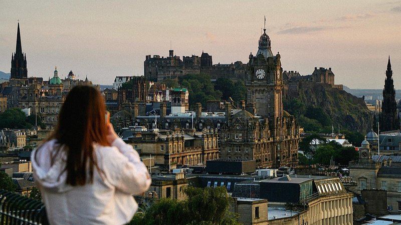 Tourist viewing skyline of Edinburgh, Scotland