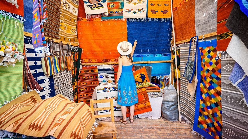 Woman admiring the handmade rugs in Oaxaca, Mexico