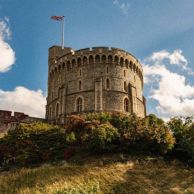 A castle tower with a British flag swaying in the air