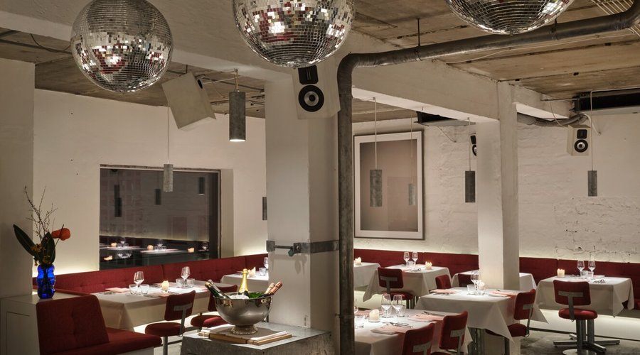 The Cookies Cream presents a harmonious blend of industrial chic and warm elegance, inviting guests into a space where modern design meets comfort. The striking contrast of exposed concrete and plush seating sets a sophisticated yet inviting tone. This unique atmosphere is perfectly suited for those seeking an elevated dining experience that balances the allure of fine dining with a relaxed, contemporary vibe.