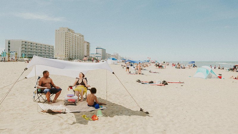 Family relaxing on the beach, in Virginia Beach