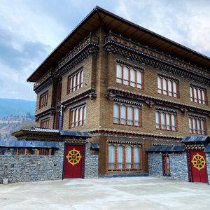 Nestled within the breathtaking landscapes of the Paro valley, Paro Eco Lodge captivates guests with its exterior, a seamless fusion of traditional Bhutanese architecture and contemporary design elements. The lodge's facade is a masterpiece crafted from locally sourced materials, featuring mud bricks that echo age-old building techniques, chiseled hand-laid stones that showcase meticulous craftsmanship, and bamboo mats that add an authentic touch to the structure. 