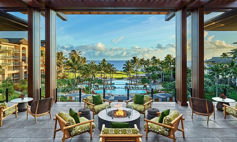 Fire pit in lobby overlooking three-tiered pool, golf course, and ocean