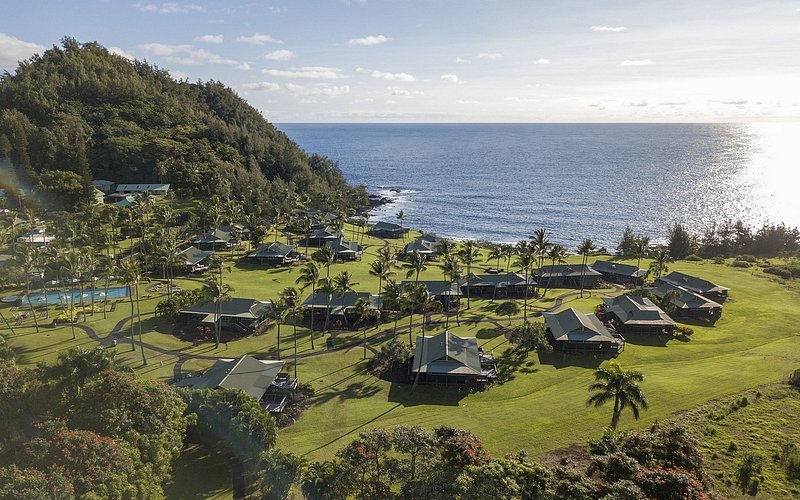 Rolling green hillsides next to ocean water at Hana Maui Resort.