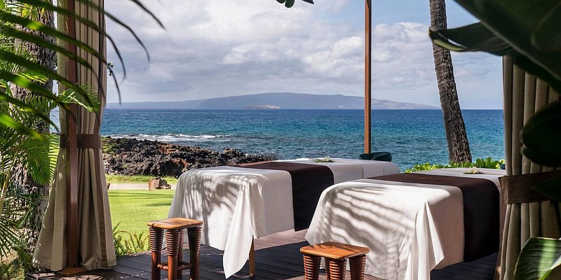 Two massage tables set up next to the beach at Wailea Beach Resort.