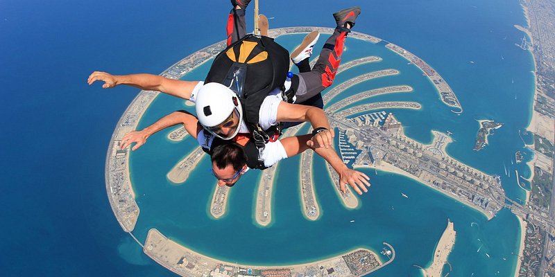 Person tandem skydiving over Dubai's Palm Jumeirah