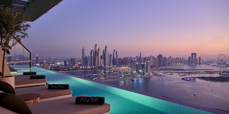 Rooftop outdoor pool overlooking Dubai skyline at sunset