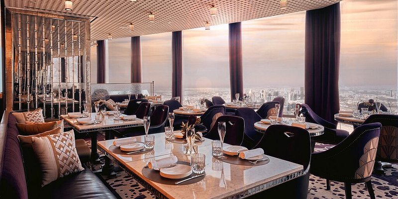 Elegant dining room with windows overlooking Dubai