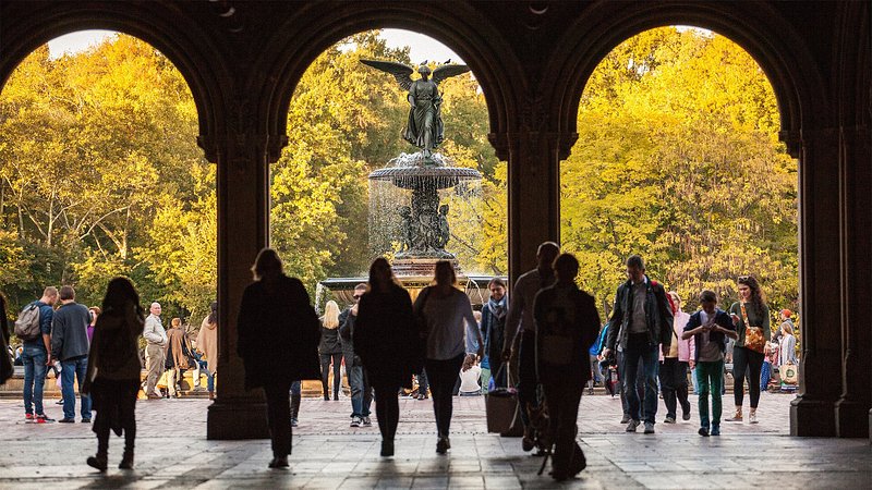 People walking in front of the Bethesda Fountain, in Central Park, New York