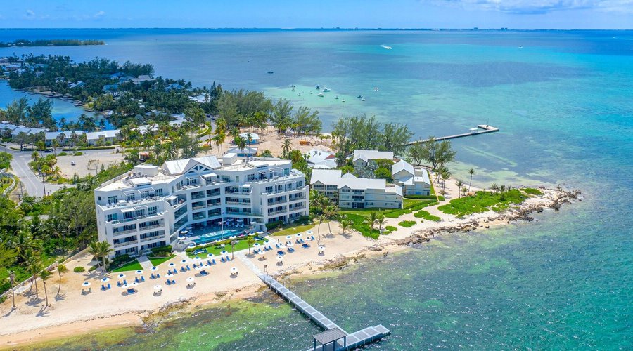 Aerial view of the resort with the Rum Point Club and the island's Bioluminescent Bay in the background. 