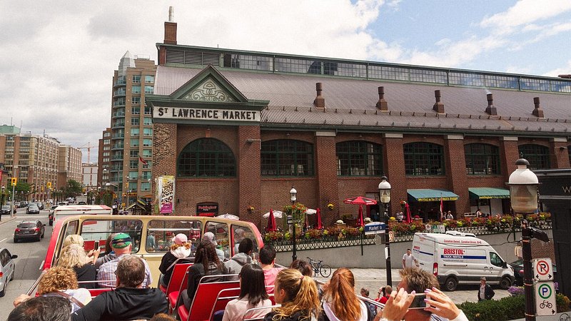 Tour bus driving by St. Lawrence Market, in Toronto 