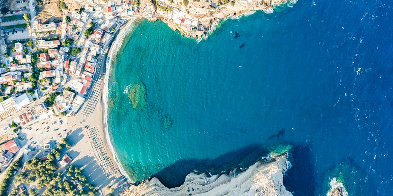 Aerial view of Matala and its beach against turquoise sea