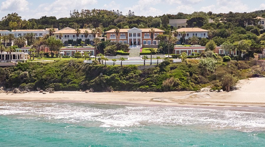 Mandola Rosa sits within exquisite gardens perched above a beach extraordinaire. Beloved by Kings & Queens its design reflects nostalgic Mediterranean palace homes. It is Rose coloured, after the almond trees that blossom in Ancient Olympia nearby.