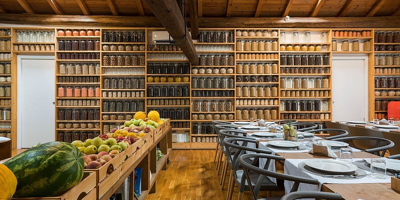 The dining room for Habitat with shelves lined in bottles.