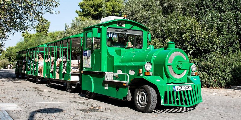A bright green trolley built to look like an old steam train.