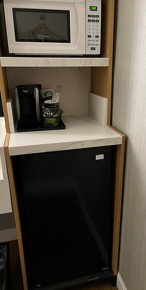 Mini-fridge, coffee maker, and microwave (to the left — not shown —large counter and sink area separate from toilet/shower to ease the morning rush!)