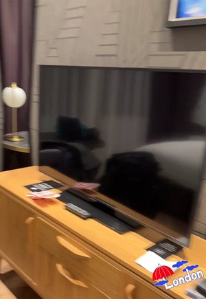 Sorry blurry image from video. TV with Chromecast and table on the side.