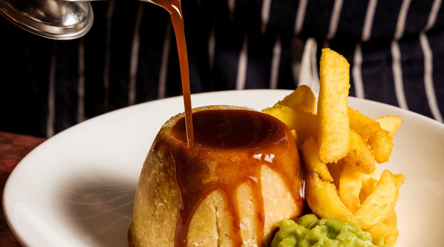 Beefsteak pudding, beef dripping chips and mushy peas. 