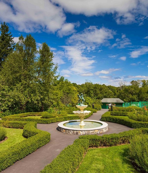 Fountain at center of well-manicured garden