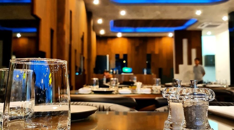 "Step into the upscale ambiance of Marush Kamala, where the dining experience is as grand as the finest Italian palazzos and as inviting as a Lebanese home. Crisp linen, sparkling glassware, and polished cutlery are set against a symphony of wood and ambient blue lighting, setting the stage for an unforgettable culinary journey that blends the best of two worlds!"