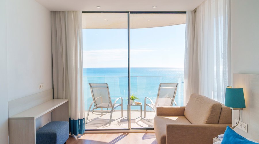 Beachfront hotel. All our rooms offer views of the Mediterranean Sea, and the hotel is walking distance from Puerto Marina. The picture shows a Double Room with Front View. Enjoy privileged views of the incredible blue Mediterranean sea. These rooms have an amazing furnished terrace with a frontal view of the sea, the hotel pool and the Marina Port. Elegant and bright rooms, with single beds or a double bed and a sofa.