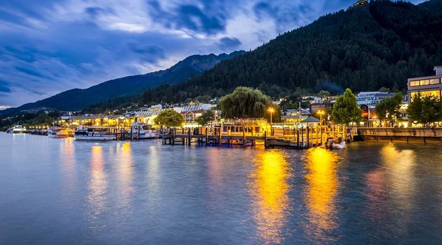 Establishments and boats by the lake at night
