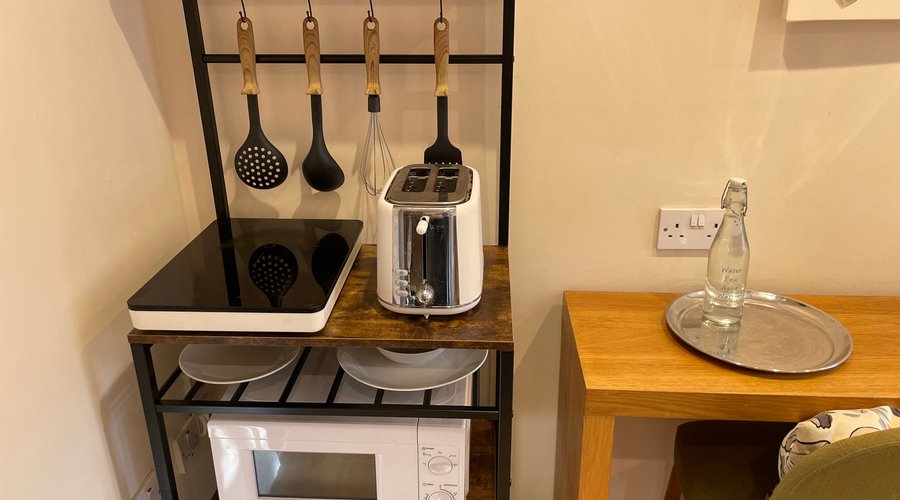 Kitchenette with microwave, induction ion hob and toaster.