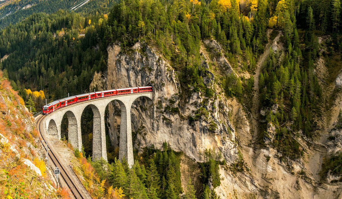 The Bernina Express in Switzerland and Italy riding over a bridge