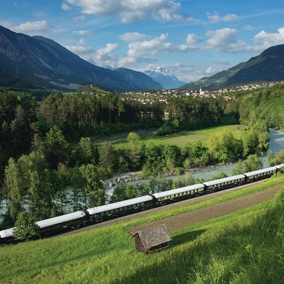 The Venice-Simplon Orient Express Train riding through the countryside in Europe.