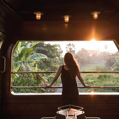 A passenger looking out of the Eastern & Oriental Express train