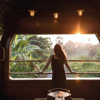 A passenger looking out of the Eastern & Oriental Express train.