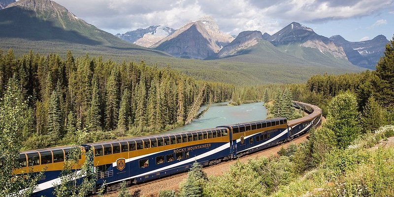 Rocky Mountaineer train on its train route through forests