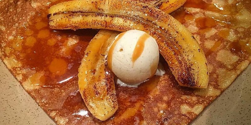 Crepe topped with grilled bananas and ice cream