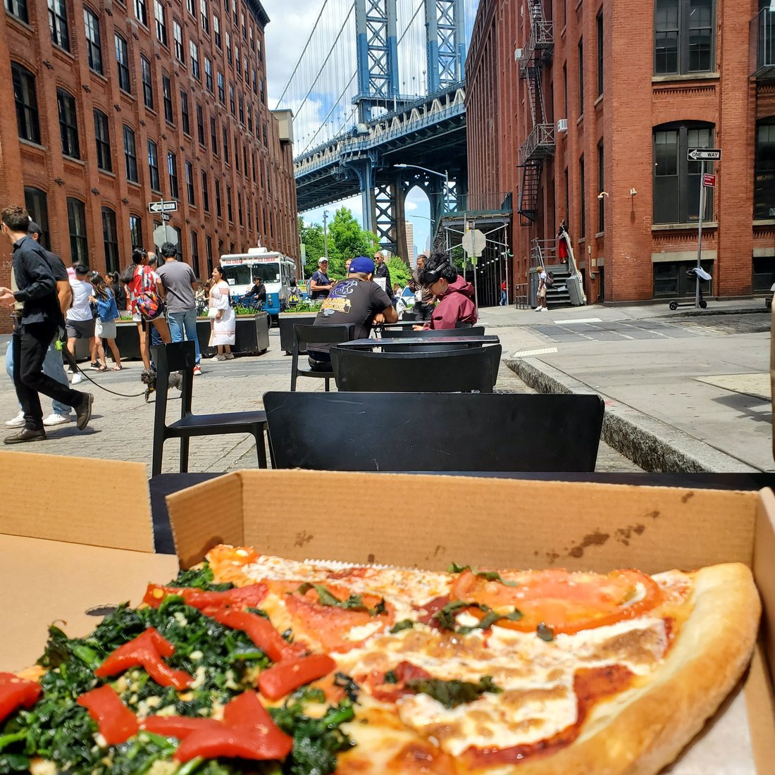 Front Street Pizza slice shop DUMBO Brooklyn with neon sign and counter seating