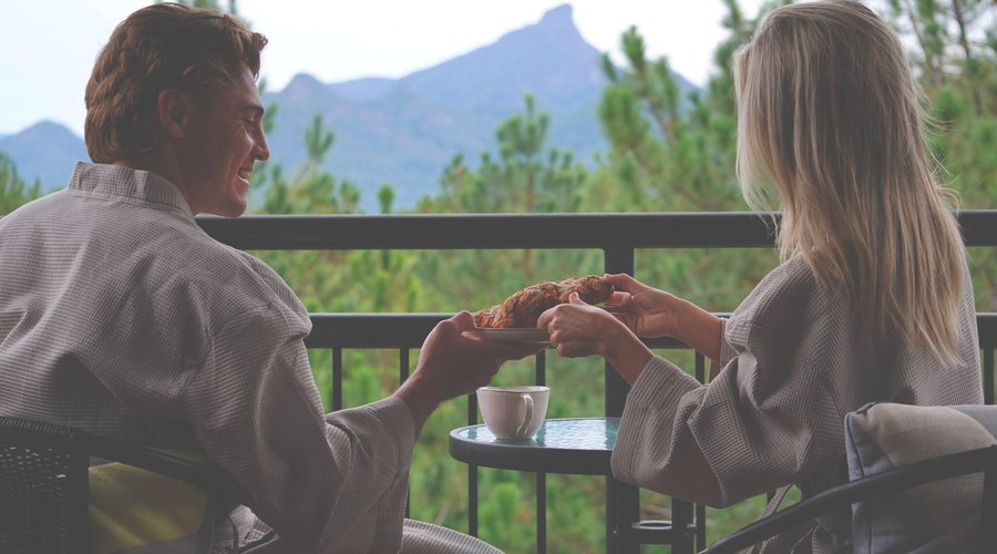 Lovers enjoying romantic breakfast,  alfresco, on their private chalet deck - Morning Mist. 