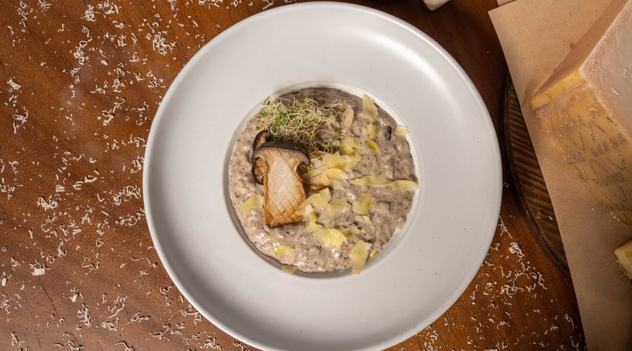 Indulge in the luxurious flavors of our Mushroom Risotto. This creamy dish features rice cooked to perfection, infused with a rich blend of earthy mushrooms. Enhanced with a splash of white wine and finished with Parmesan and a touch of whipping cream, our Mushroom Risotto delivers a decadent and velvety texture. Garnished with fresh herbs, it offers a delightful harmony of flavors that promises to tantalize your taste buds.