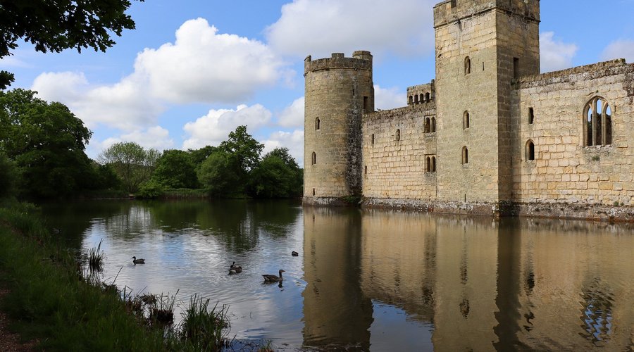 A wide moat encircles the seemingly untouched Medieval exterior.